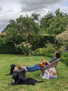 Milla knitting while dogsitting in England