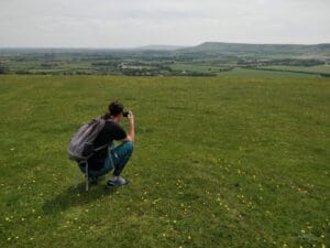Milla crunching down to take pictures in English countryside