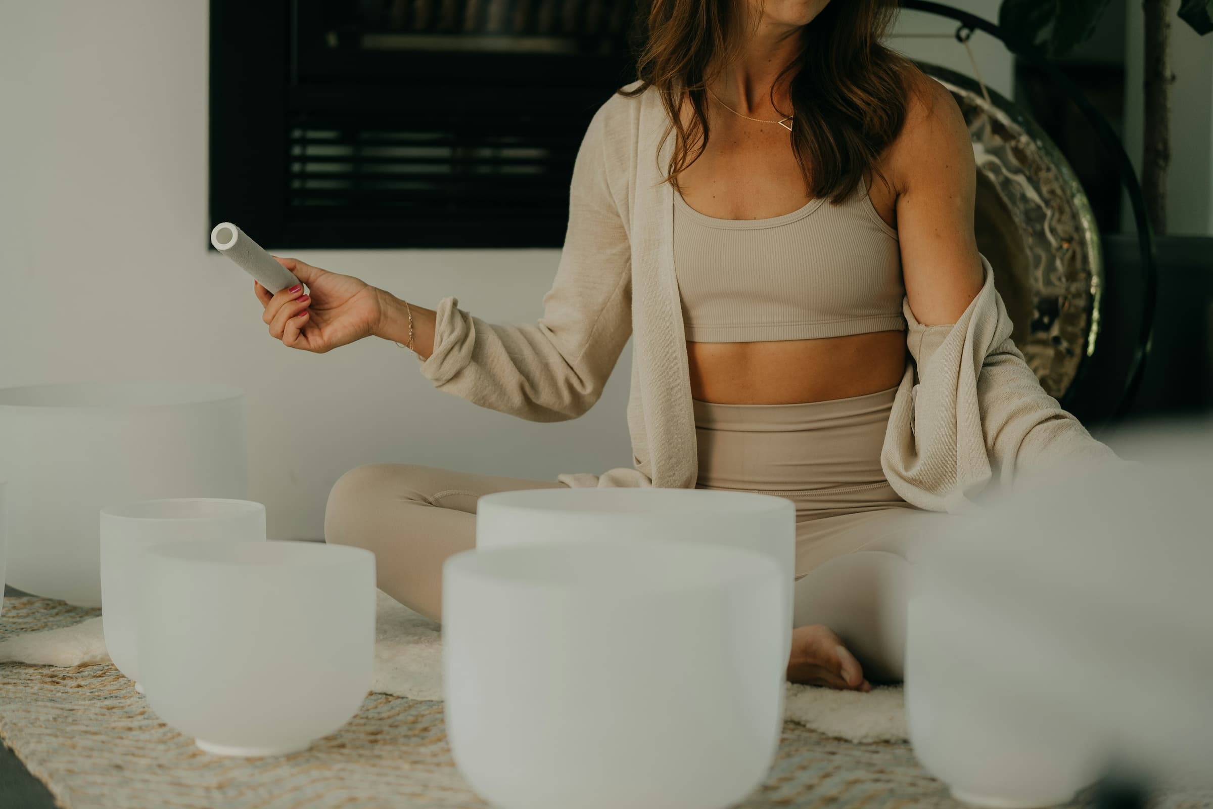 yoga teacher with singing bowls